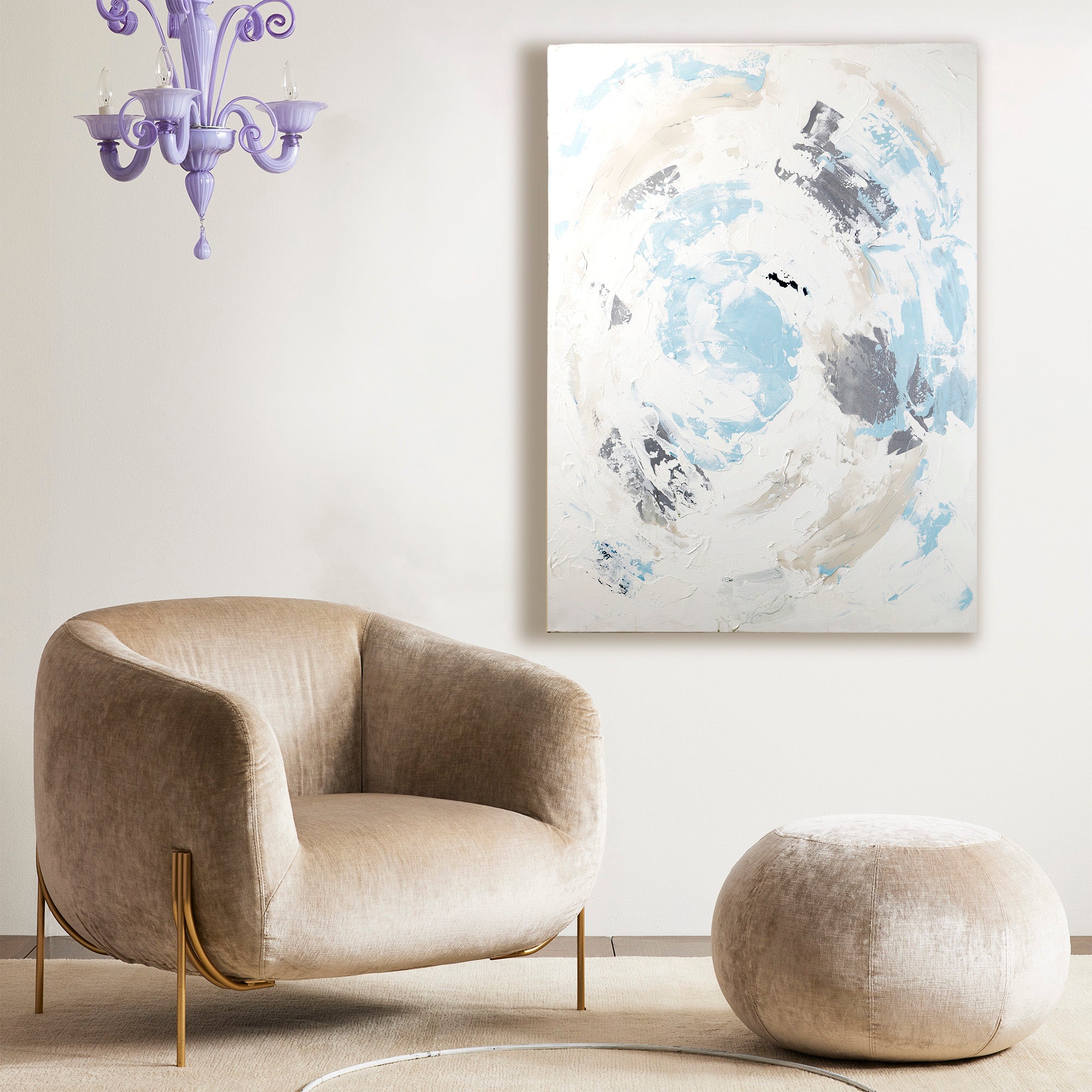 Iris Dankner abstract artwork on wall in a small living room scene with chair and ottoman