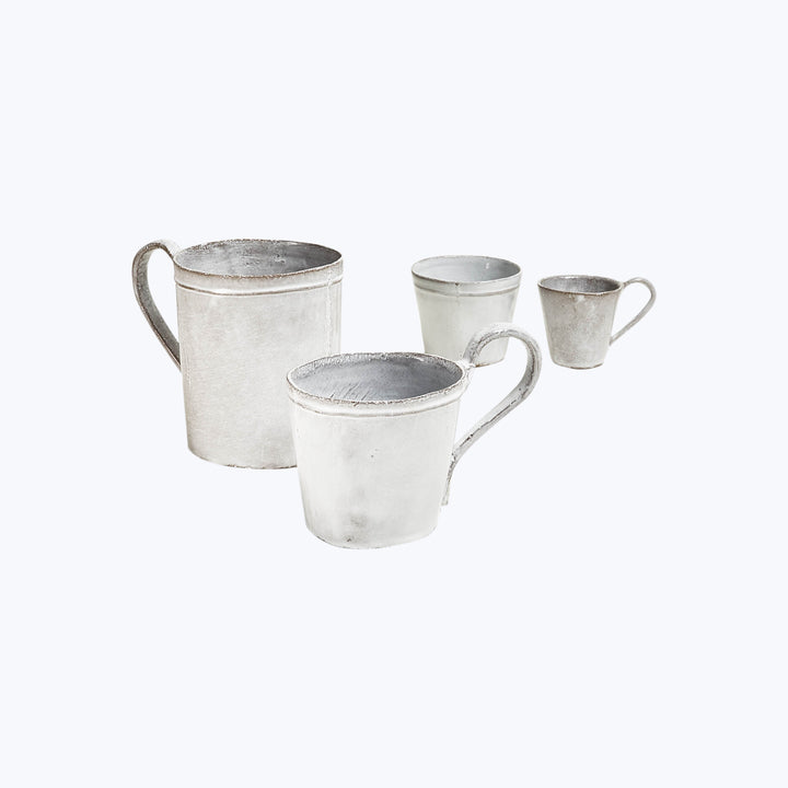 Set of four metallic vintage mugs in descending size order.