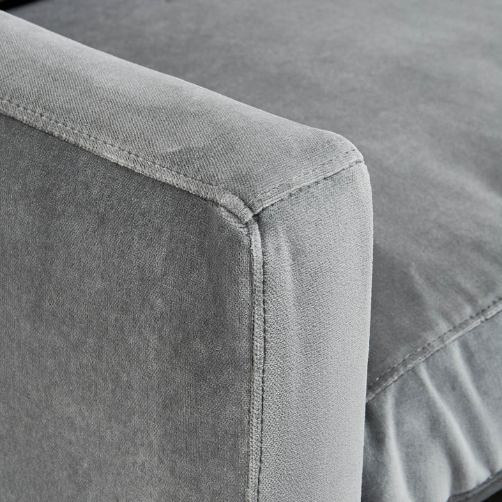 Close-up of grey upholstered furniture showcasing meticulous craftsmanship and texture.