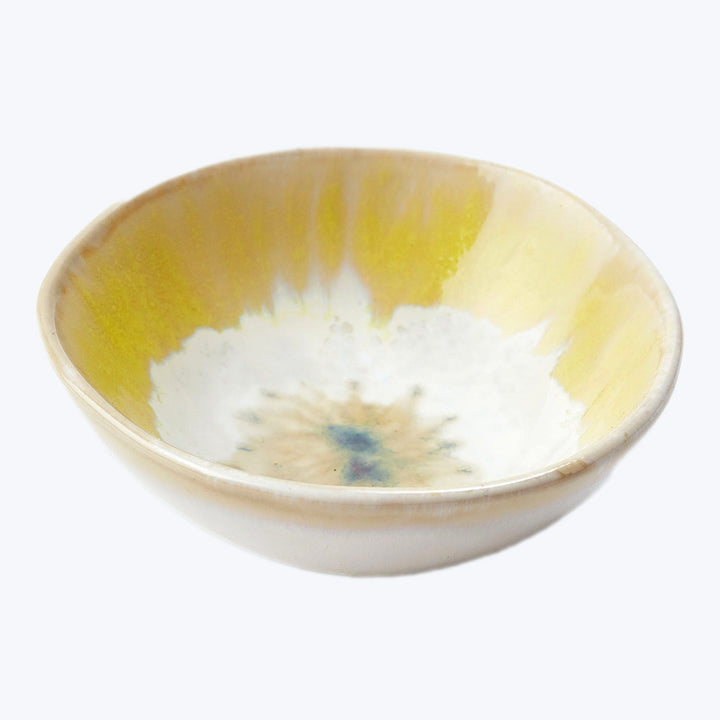 Handmade ceramic bowl with yellow rim, blue center, watercolor effect.