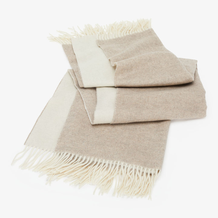 Cozy throw blanket and pillow set in natural tones and textures.