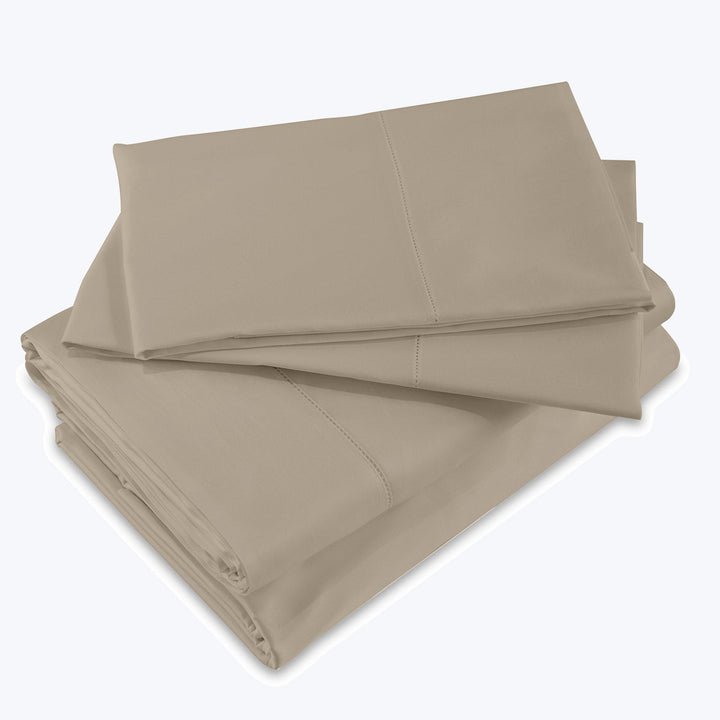 Neatly folded beige bed sheets with visible stitching lines.