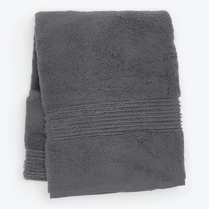 Soft plush gray bath towel with decorative border, clean and unused.