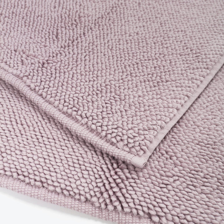Close-up of plush lilac textured fabric with looped pile.