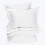 Set of white bedding items including duvet cover and pillowcases.