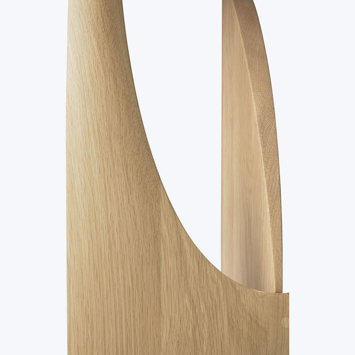 Close-up of smooth, curved oak wood with vertical joint strip.