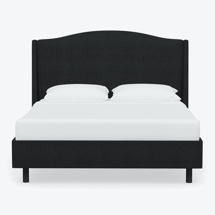 Modern minimalist bed with dark upholstered headboard against white background.
