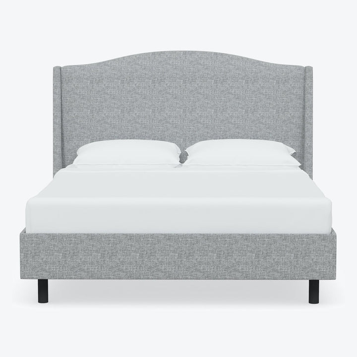 Minimalistic and contemporary bed with grey upholstered headboard and clean design.