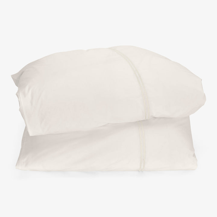 Two white pillows stacked neatly on top of each other.