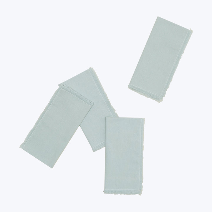 Set of three light blue fabric swatches on white background
