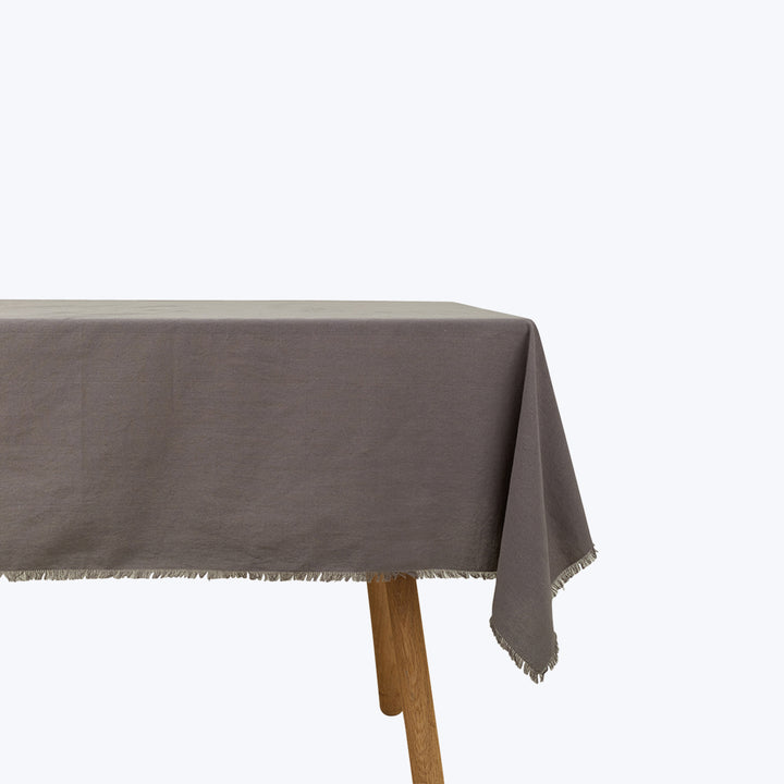 Wooden table with grey linen tablecloth in studio setting display
