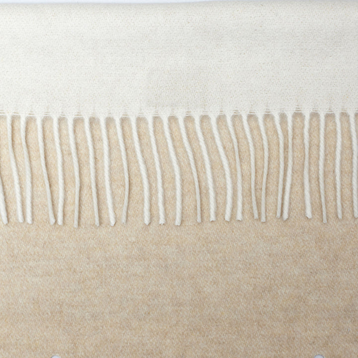 Close-up of frayed fabric edge with individual strands hanging loose.