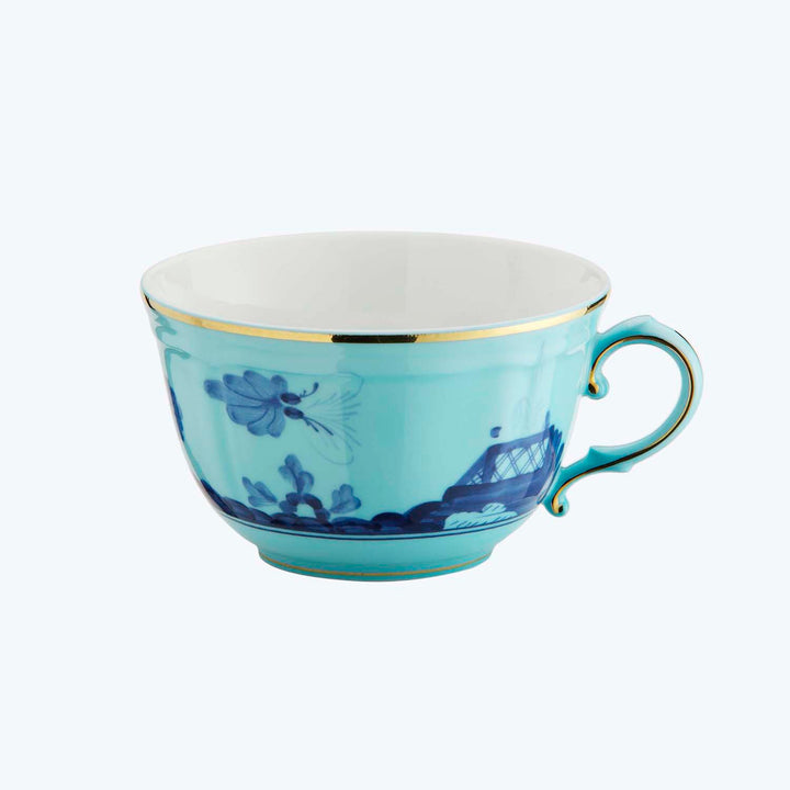 Elegant porcelain cup with blue floral design and gold accents.