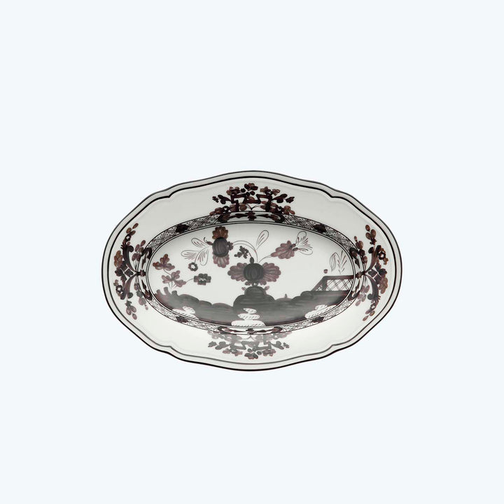 Oval ceramic plate with floral pattern in white, brown, black.