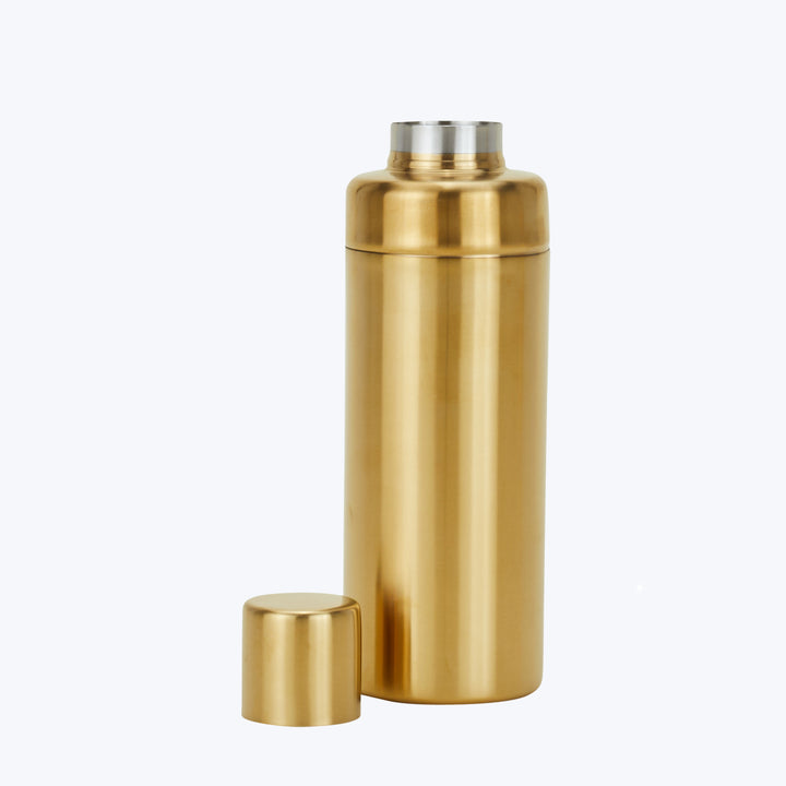 Golden cocktail shaker with sleek design and metallic finish.