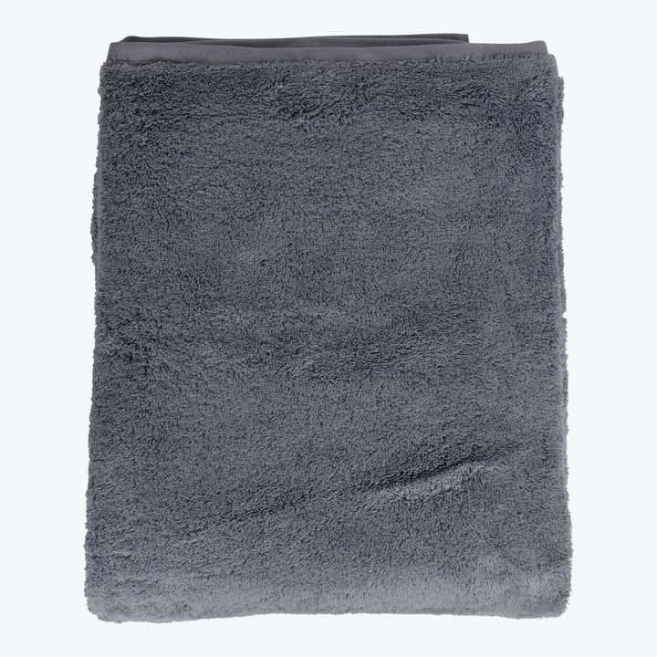 Soft, fluffy gray terrycloth towel neatly folded on white background.