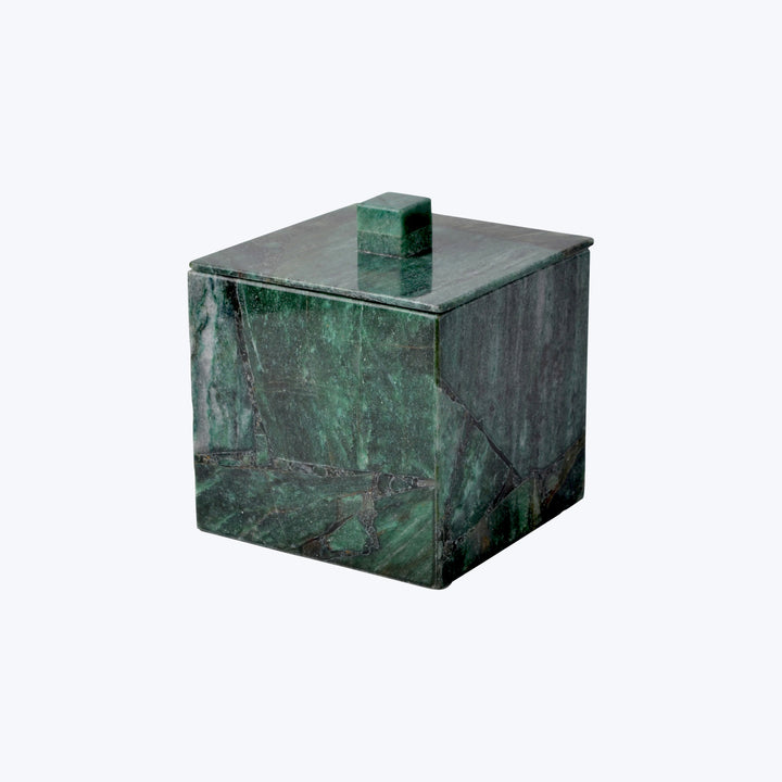 Employee standing with crossed arms in front of office door.