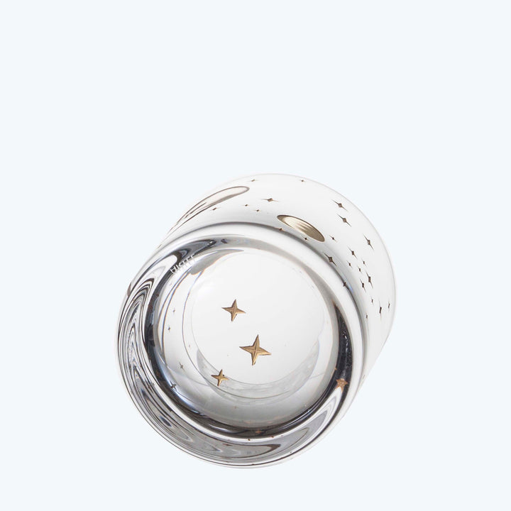 Clear glass paperweight with star and dot pattern, elegant design.