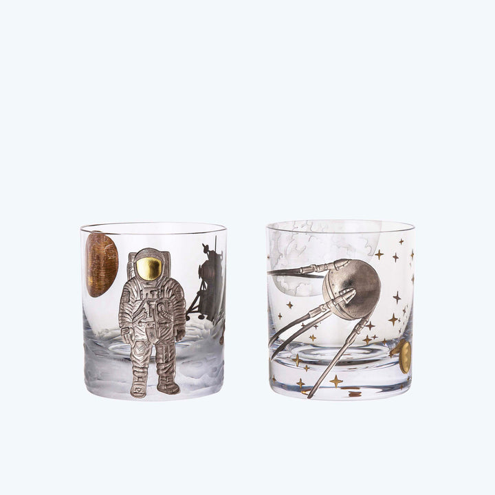 Space-themed drinking glasses with intricate astronaut and satellite designs.