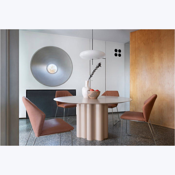 Modern dining room with minimalist design, mix of textures, sleek furniture.