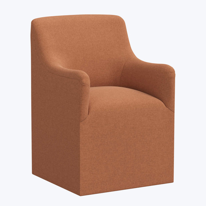 Modern rust-colored armchair with cozy design and ample cushioning.