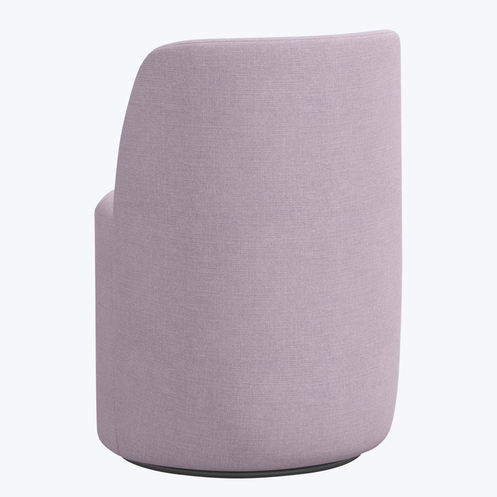 Modern chair with curvaceous design in light purple upholstery.