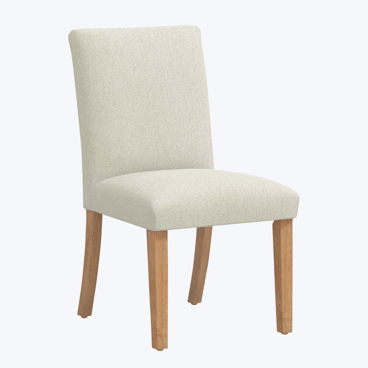 Modern dining chair with beige fabric upholstery and wooden legs.