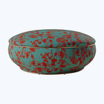 Colorful split-design cushion with floral pattern on turquoise background, versatile storage.