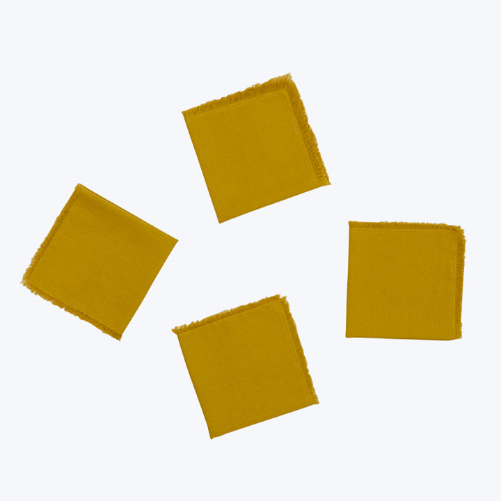 Five yellow fabric swatches with frayed edges on plain background.