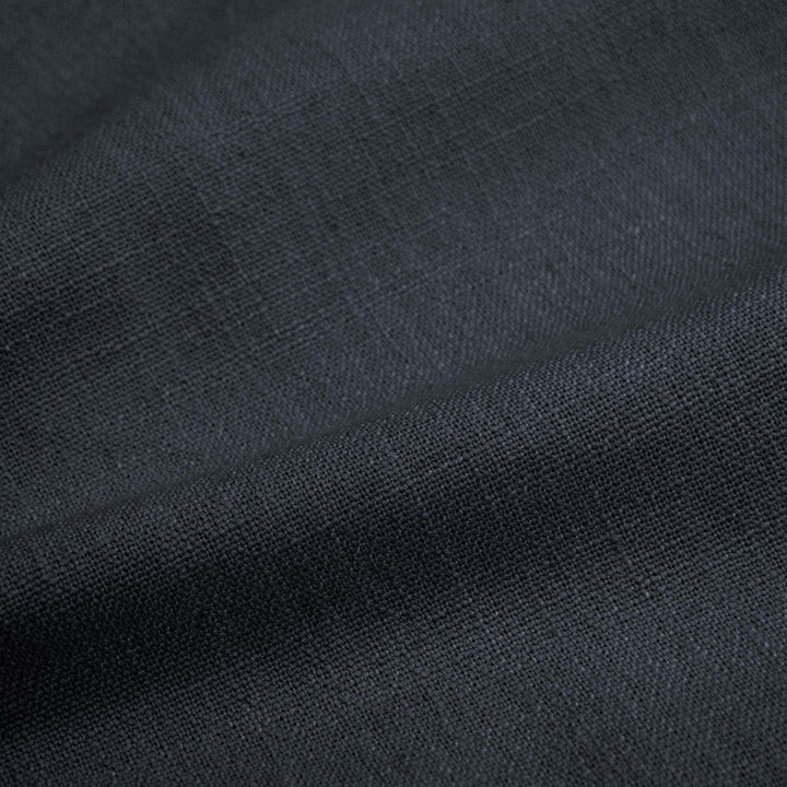 Close-up view of dark textured fabric with visible weave pattern.