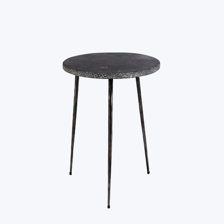 Modern round table with stone-like top and metal legs.