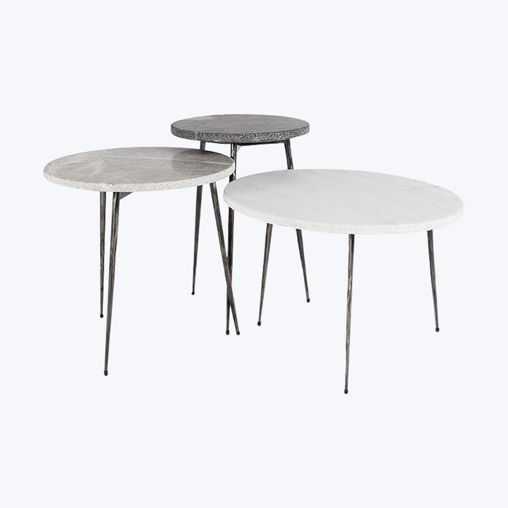 Set of three nesting coffee tables with varying heights and textures.