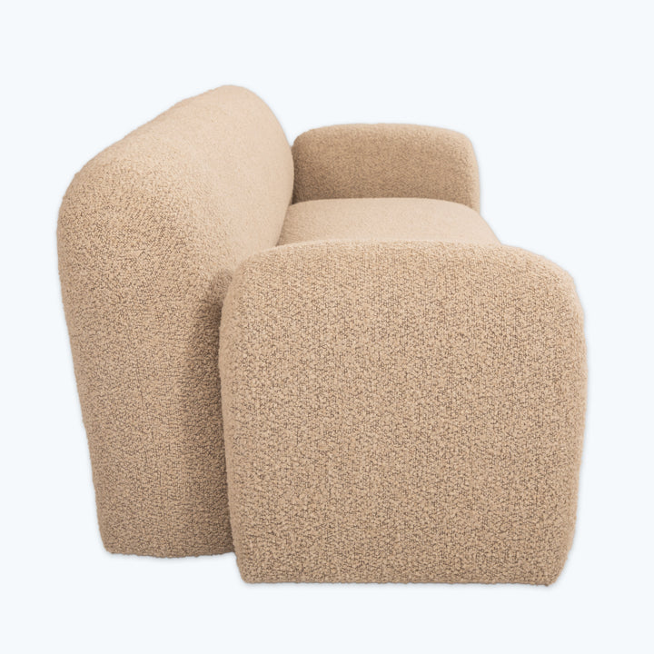 Modern beige armchair with sleek design on clean white background.