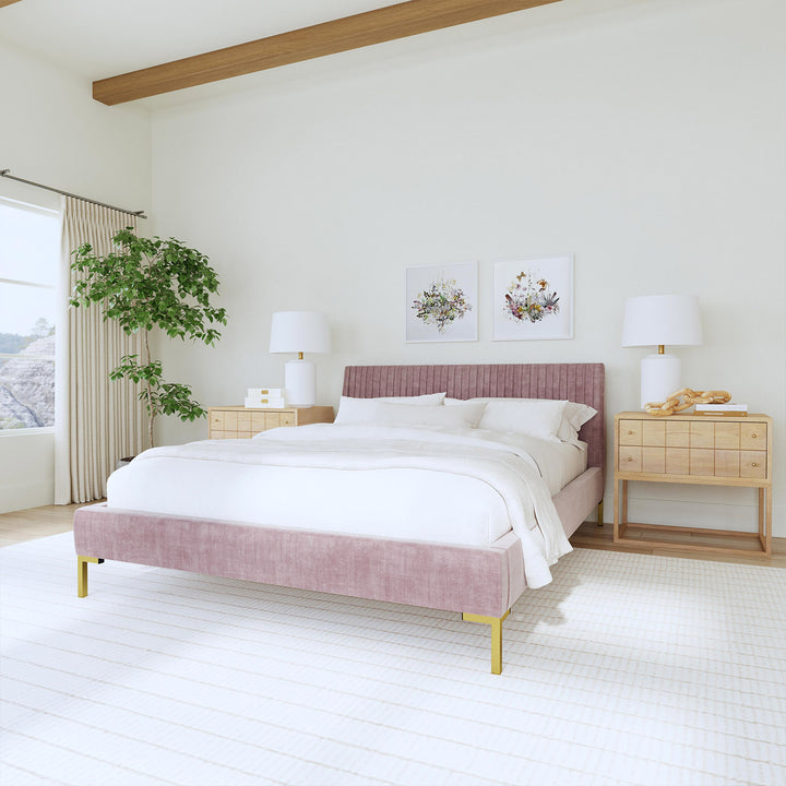 Modern, serene bedroom with pink bed frame, floral art, nature.