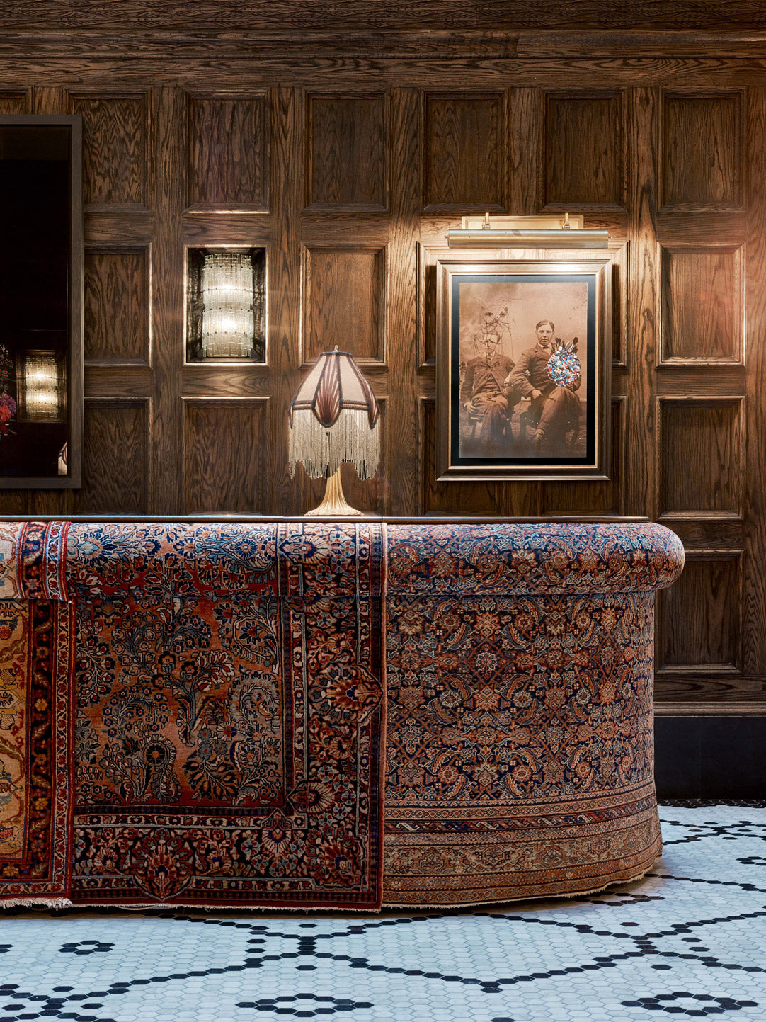 Classic vintage interior featuring rich wood paneling and ornate rug.