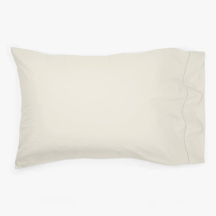 Soft neutral pillowcase on pillow, clean design, online retail display.