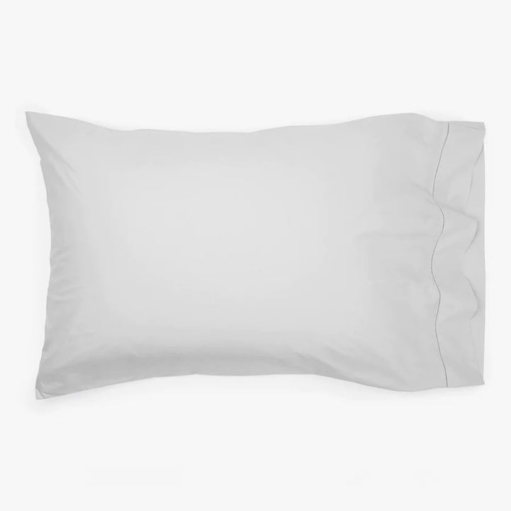 Plain white standard size pillowcase with seam and flap detail.