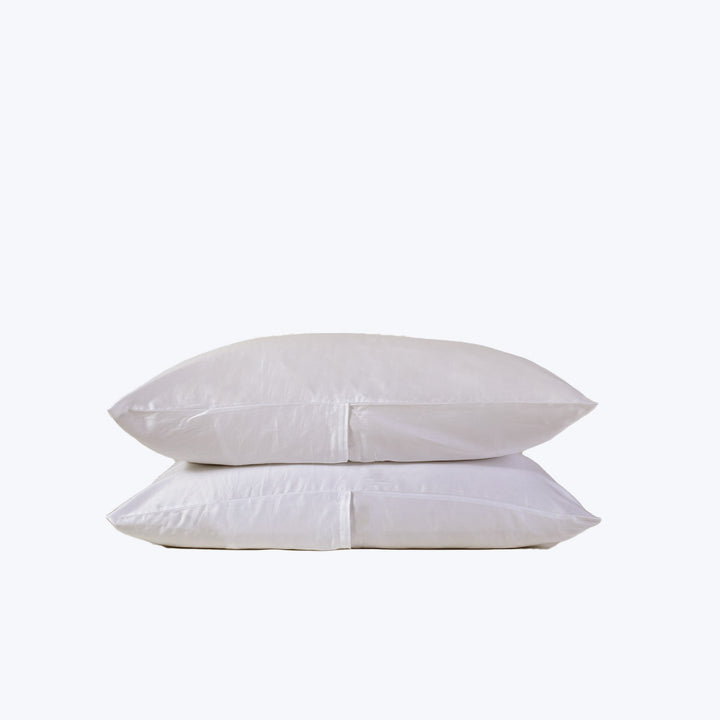 Two plain white pillows stacked on top of each other.