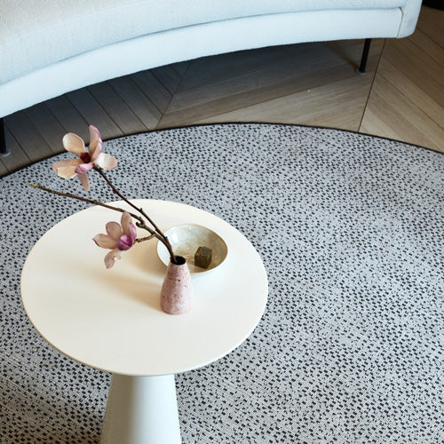 Minimalist-modern interior with sleek furniture and a touch of pink.