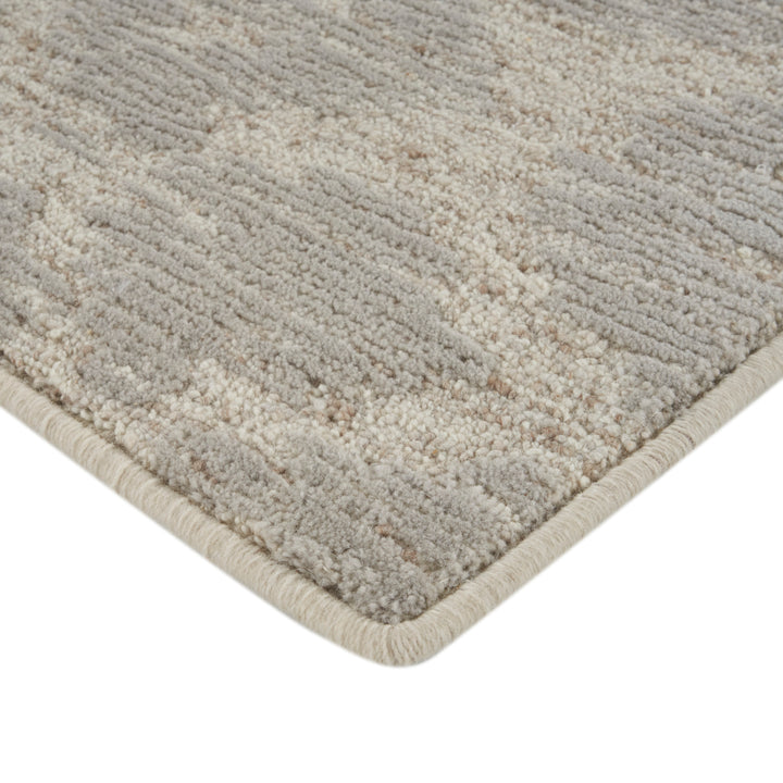 Plush grey and beige speckled area rug with finished edge.