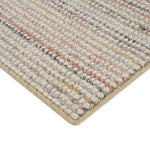 Close-up of plush loop pile rug with gray, white, red.