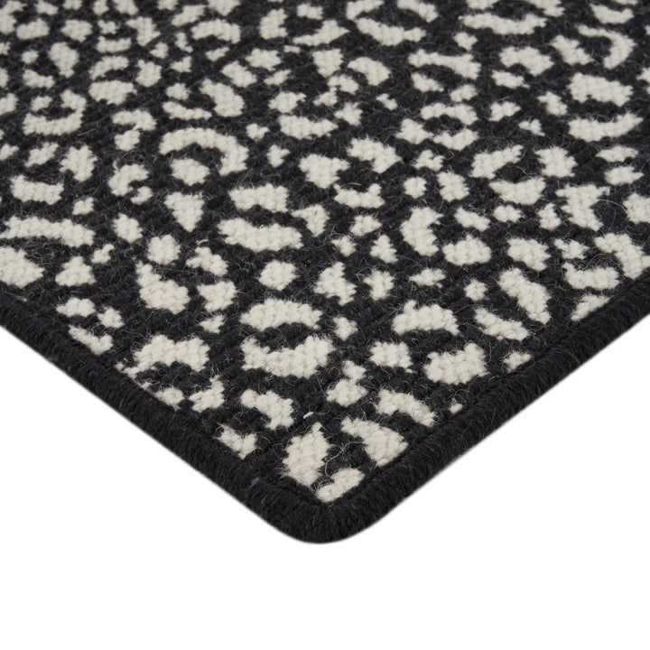 Close-up of two-toned geometric lattice rug with plush texture.