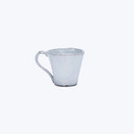 Minimalistic white ceramic cup on white background, rustic handmade design.