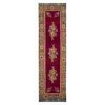 Rich maroon runner rug with symmetrical floral motifs and ornate border.