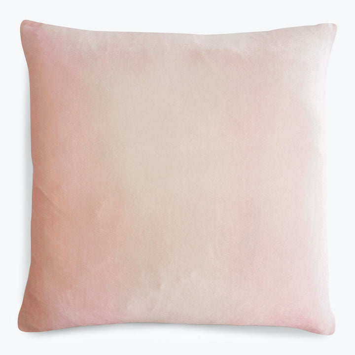 Square pink pillow with a soft watercolor-like gradient design.
