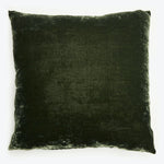 Square plush cushion with velvet-like texture in dark color.