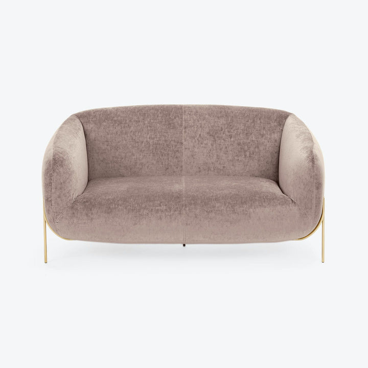 Minimalist modern sofa in blush-tone upholstery exudes elegance and comfort.