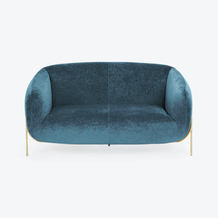 Contemporary teal velvet sofa with curved design and golden legs.