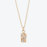 Elegant gold pendant necklace with diamond-like stones on linked chain.