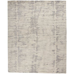 Rectangular area rug with modern distressed brush-stroke design in grayscale.